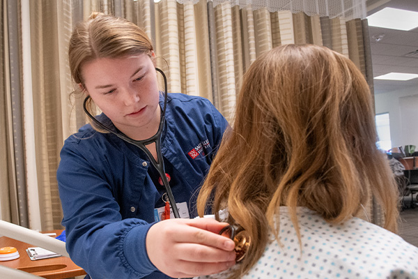 A student using a stethoscope
